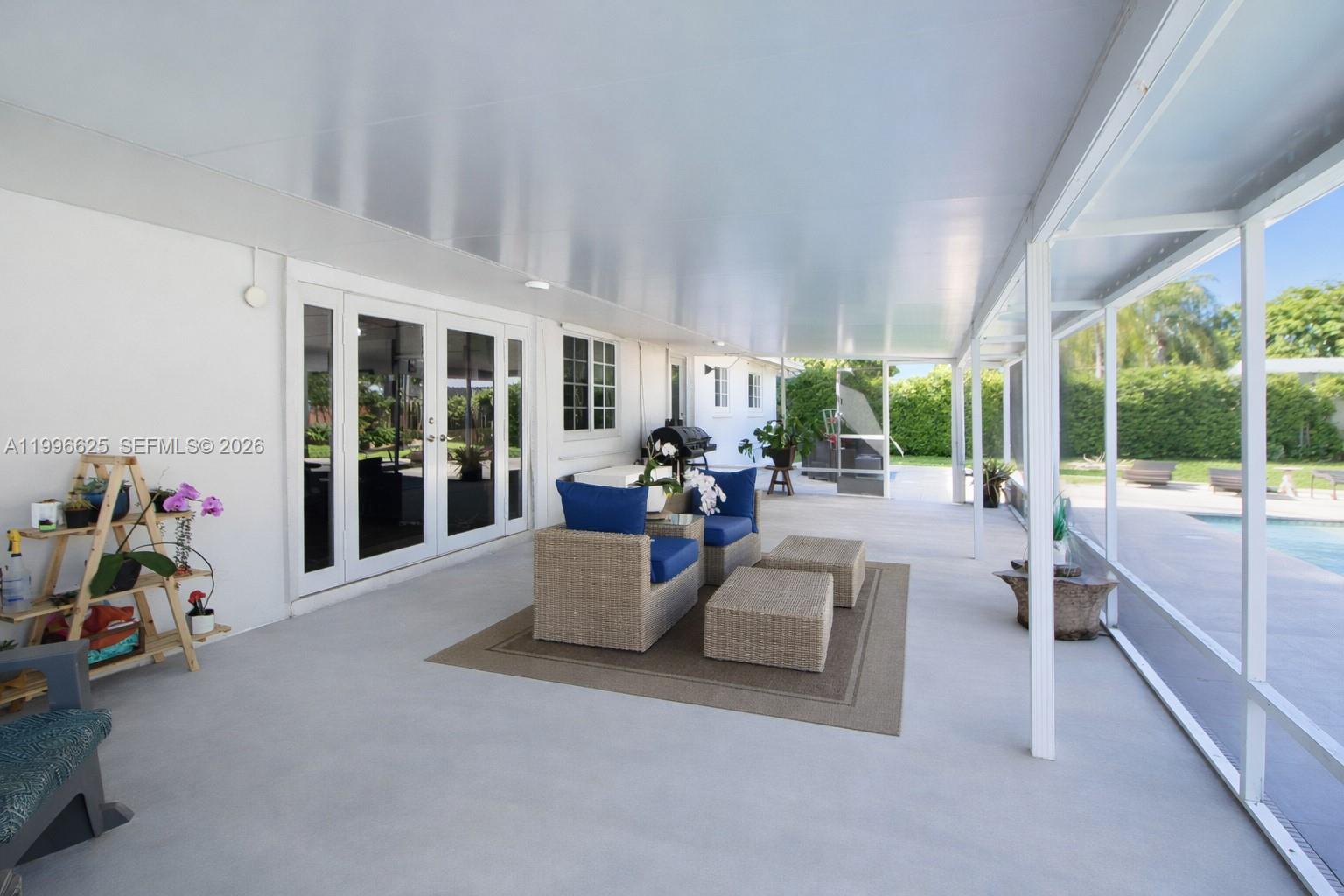 27420 Southwest 165th Avenue Homestead, FL 33031 - Photo 23 of 35 a living room with furniture and large windows