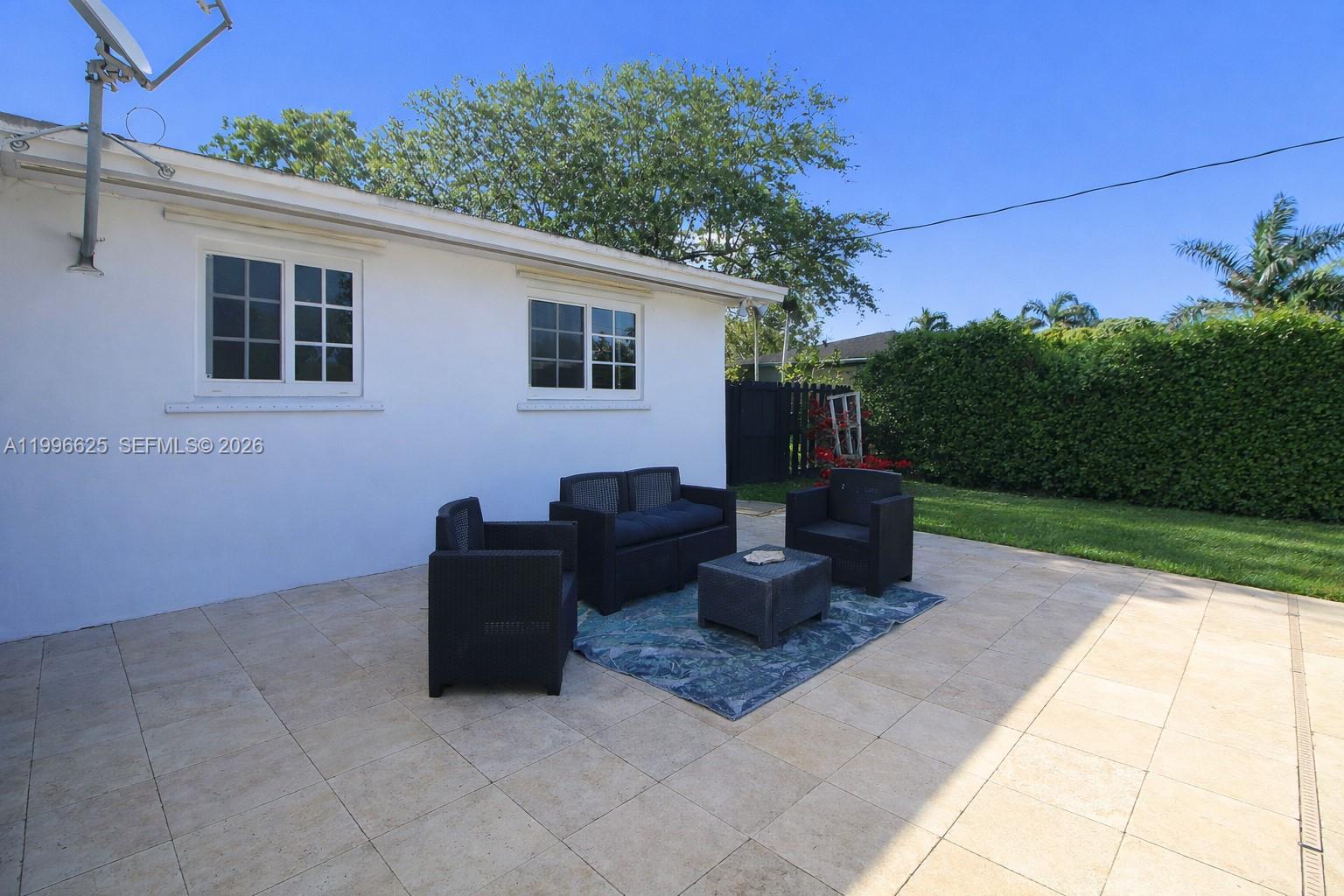 27420 Southwest 165th Avenue Homestead, FL 33031 - Photo 24 of 35 a view of a patio with couches and potted plants