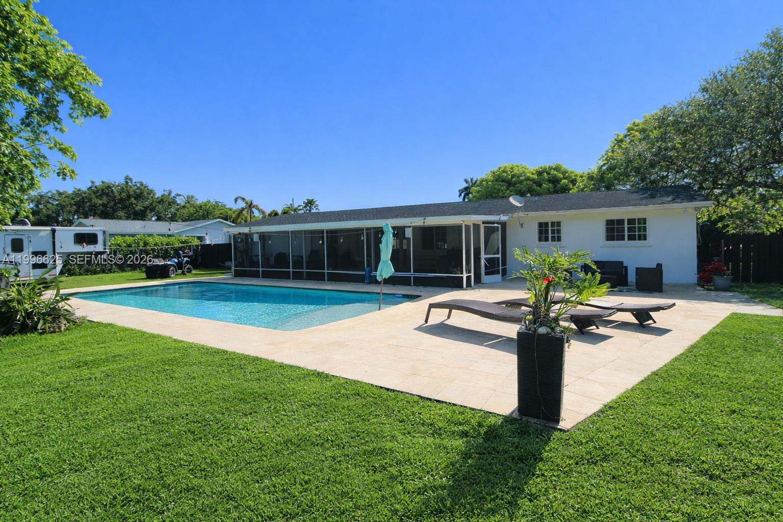 27420 Southwest 165th Avenue Homestead, FL 33031 - Photo 27 of 35 a view of a house with swimming pool and a yard