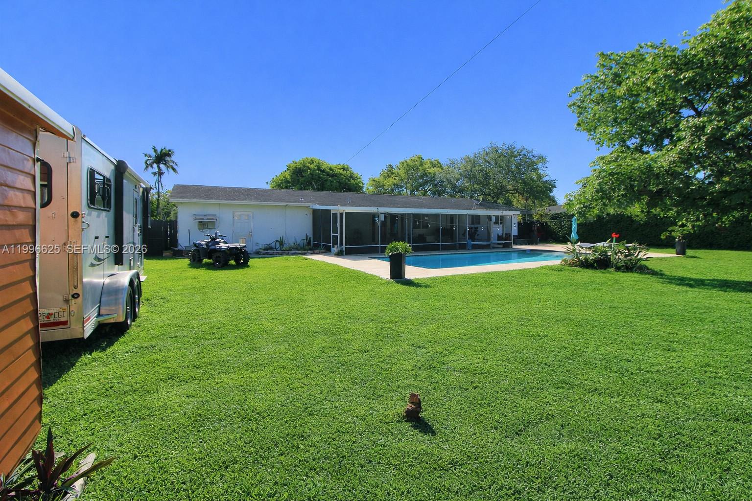 27420 Southwest 165th Avenue Homestead, FL 33031 - Photo 33 of 35 a view of a backyard with a patio and swimming pool
