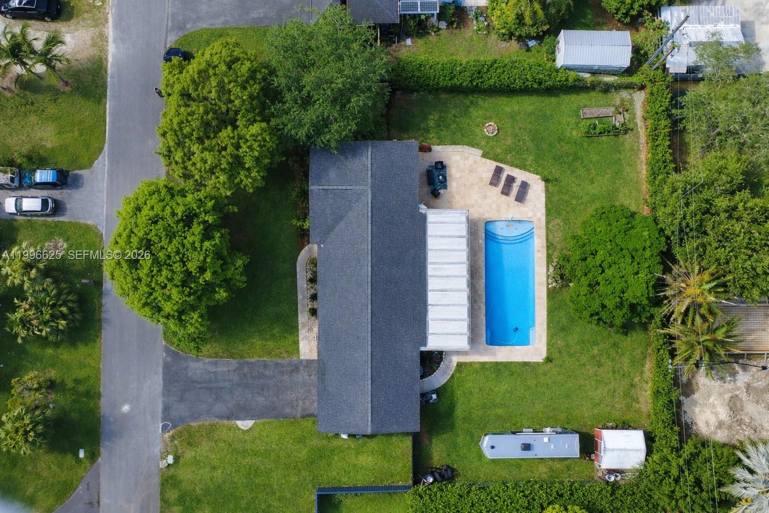 27420 Southwest 165th Avenue Homestead, FL 33031 - Photo 4 of 35 an aerial view of a house with a yard and lake view