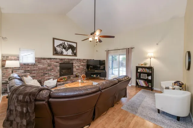 a living room with furniture a fireplace and a chandelier