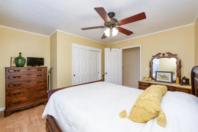 a bedroom with a bed and dresser