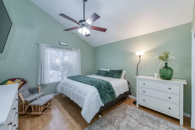 a bedroom with a bed and a chandelier