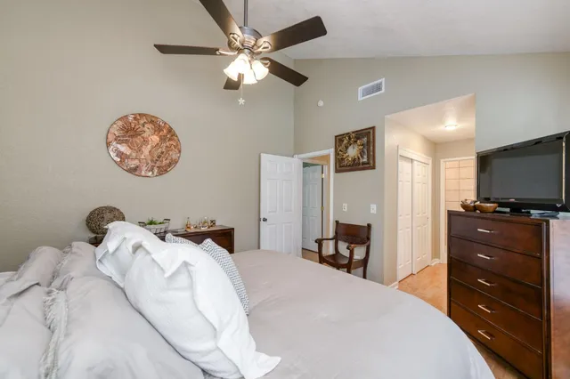 a bedroom with a bed and a chandelier