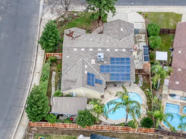 an aerial view of multiple houses with a yard