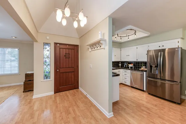 a kitchen with a refrigerator and a sink