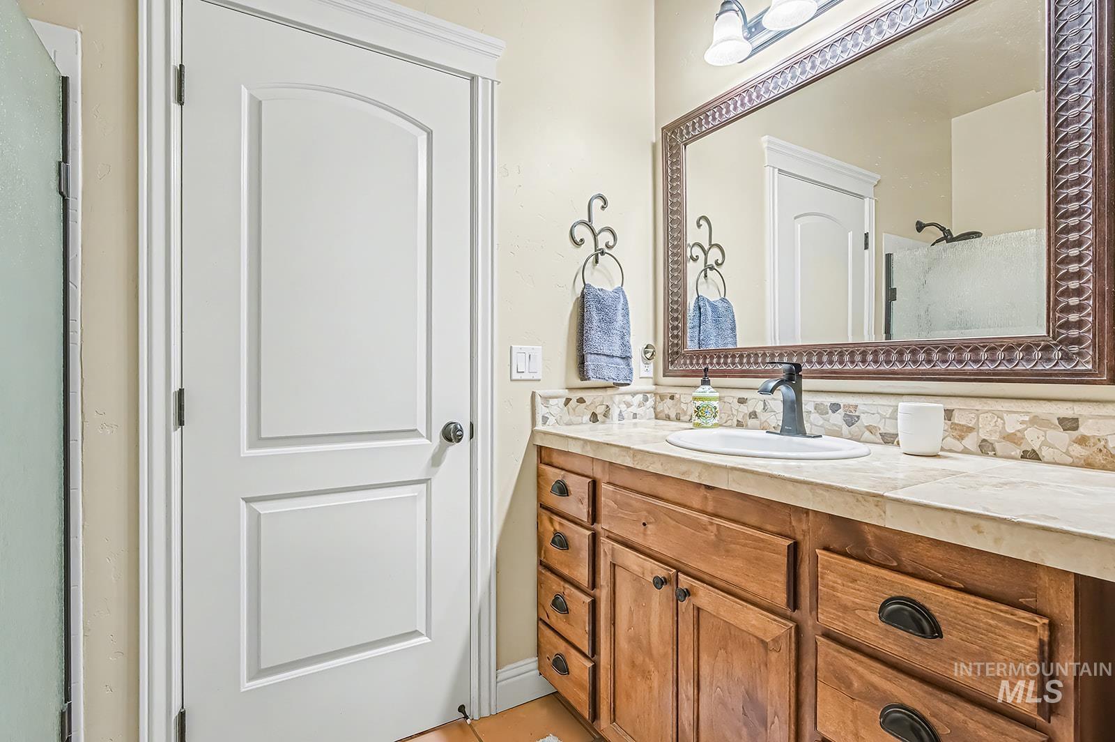 8751 West Rioja Street Star, ID 83669 - Photo 21 of 34 Bathroom vanity featuring a single basin, wood-finish cabinetry, and a textured countertop