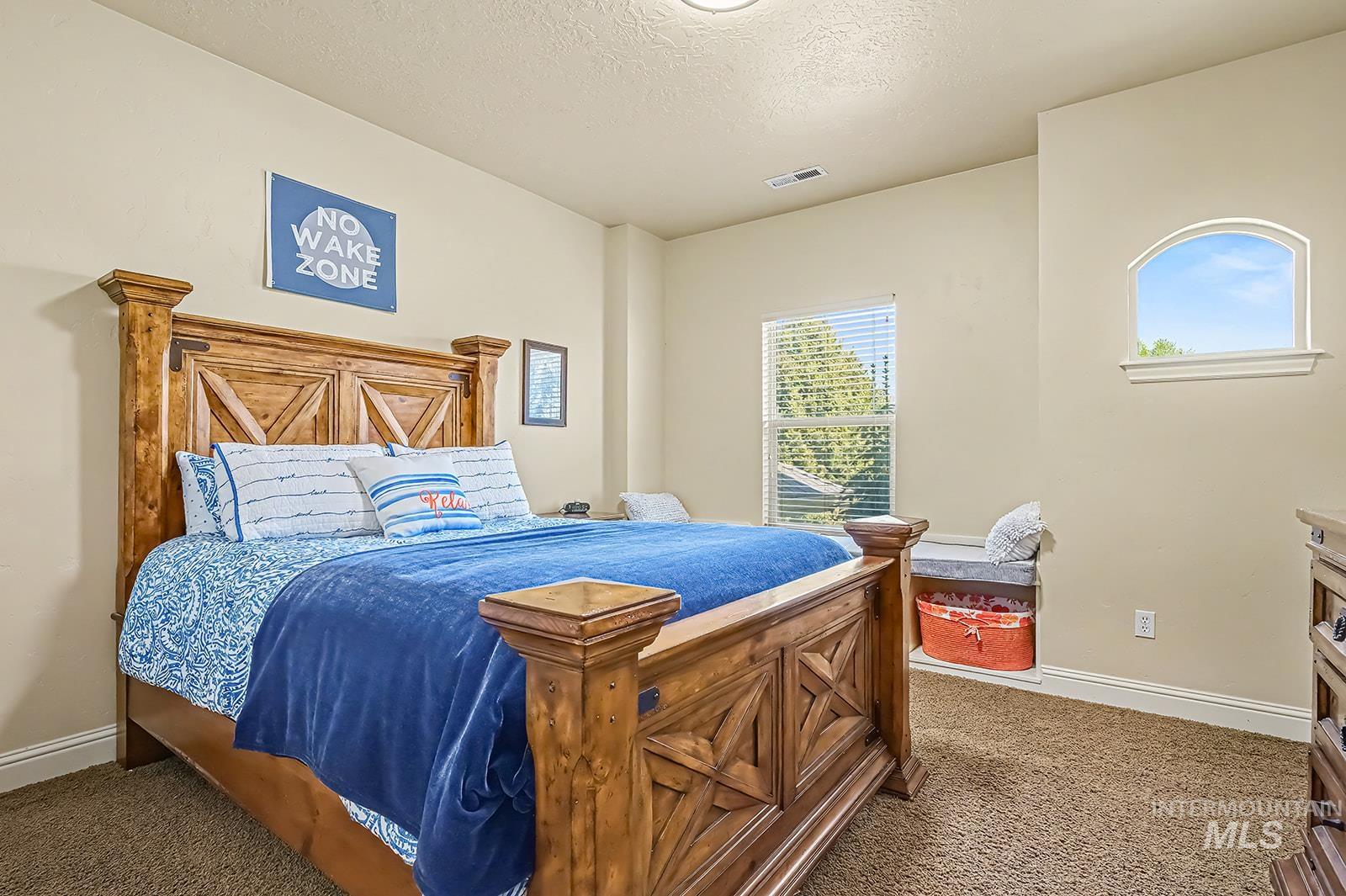 8751 West Rioja Street Star, ID 83669 - Photo 23 of 34 Bedroom featuring textured beige walls and brown carpeting