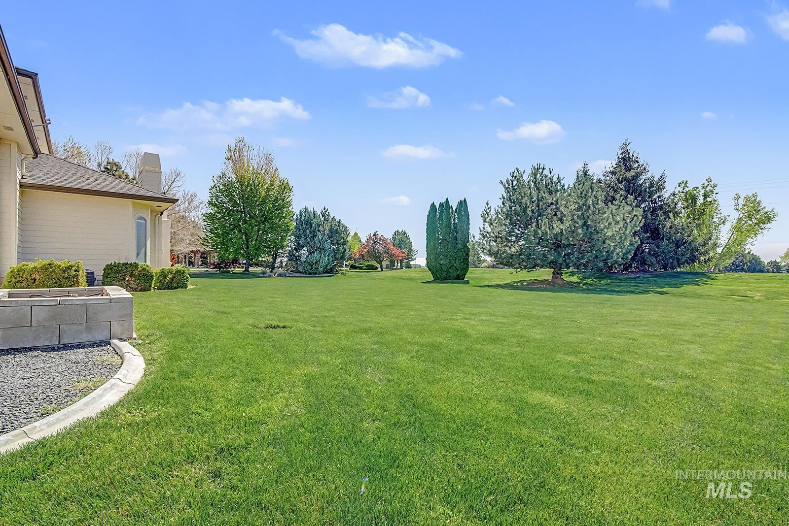 8751 West Rioja Street Star, ID 83669 - Photo 29 of 34 Expansive green lawn with mature trees and professional landscaping