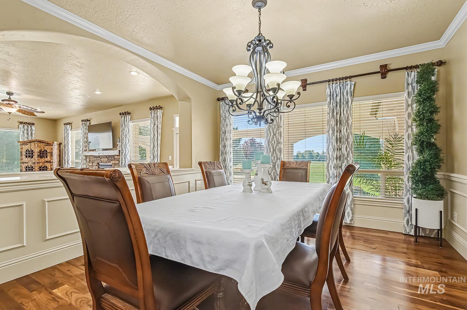 8751 West Rioja Street Star, ID 83669 - Photo 4 of 34 Formal dining area featuring hardwood flooring, crown molding, and a decorative chandelier