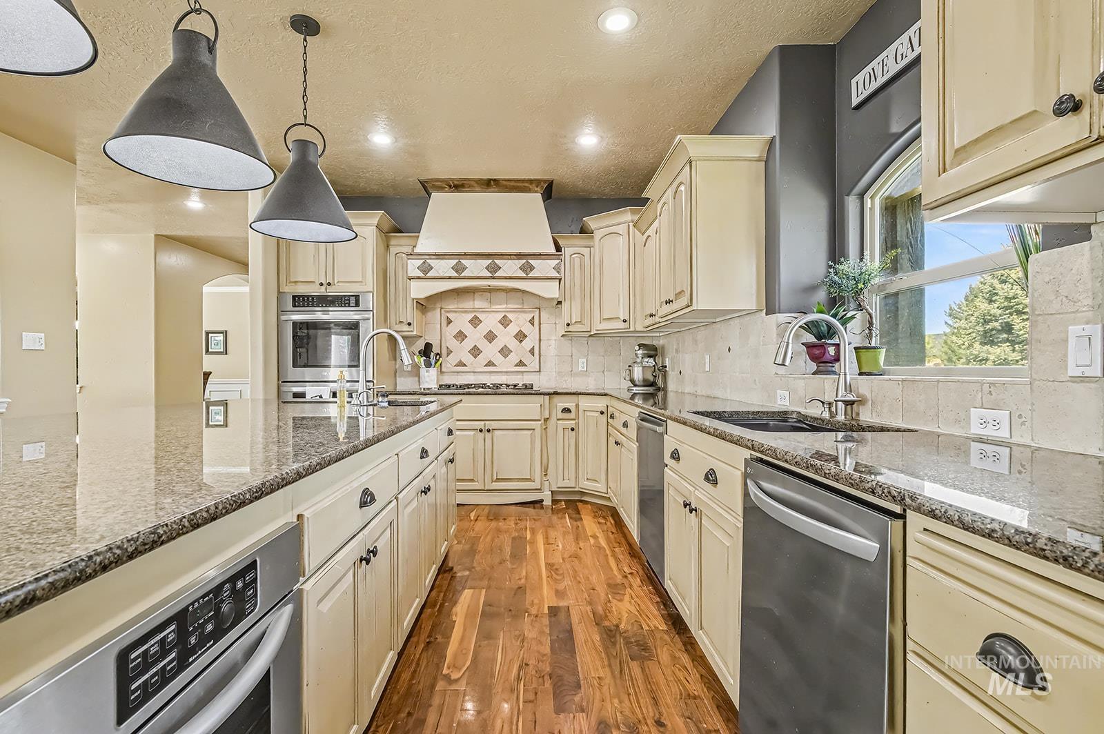 8751 West Rioja Street Star, ID 83669 - Photo 6 of 34 Kitchen featuring wood-finish flooring and cream cabinetry with dark hardware