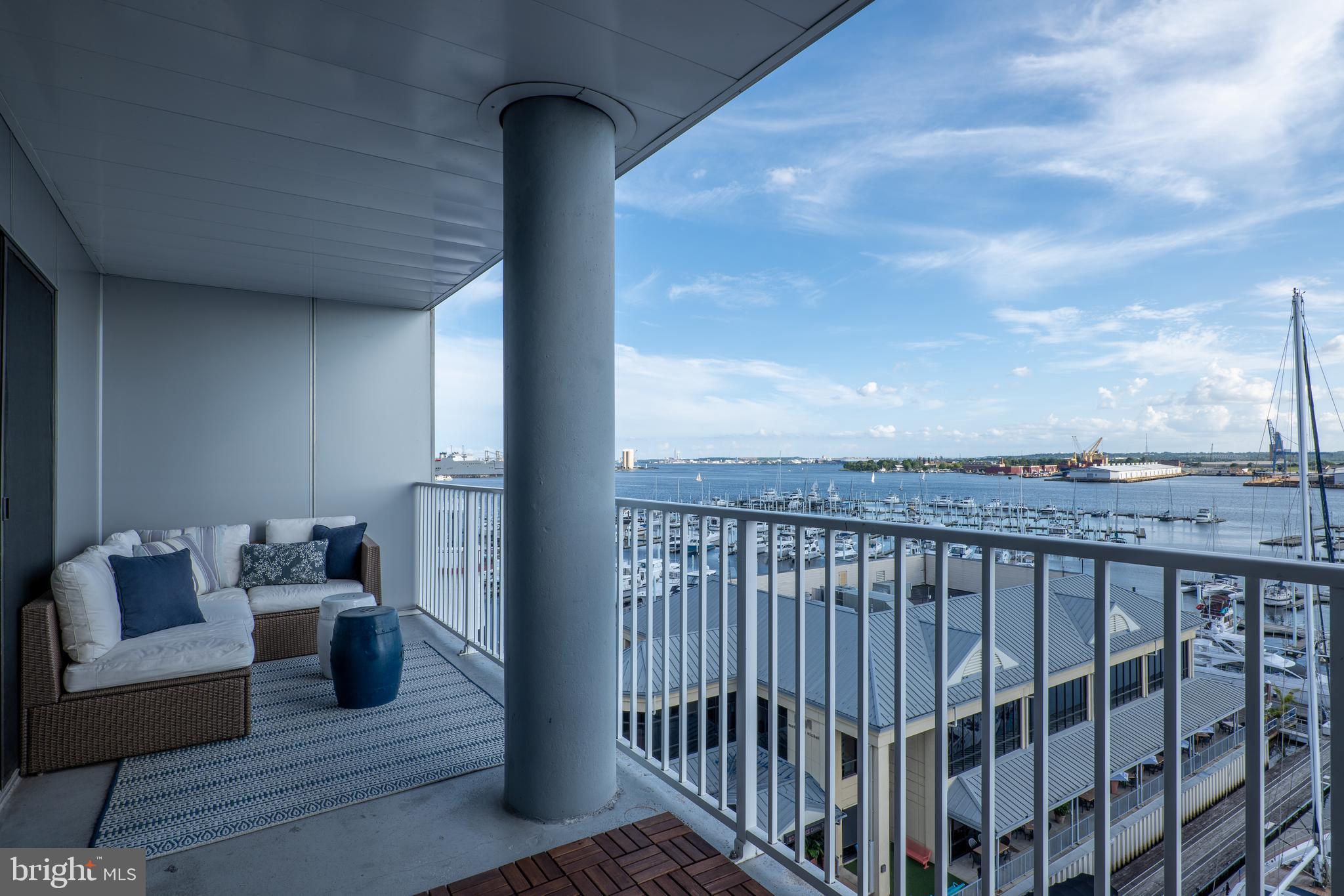 2702 Lighthouse Point East, Unit 637 Baltimore, MD 21224 - Photo 2 of 37 a view of a balcony with couches and wooden floor