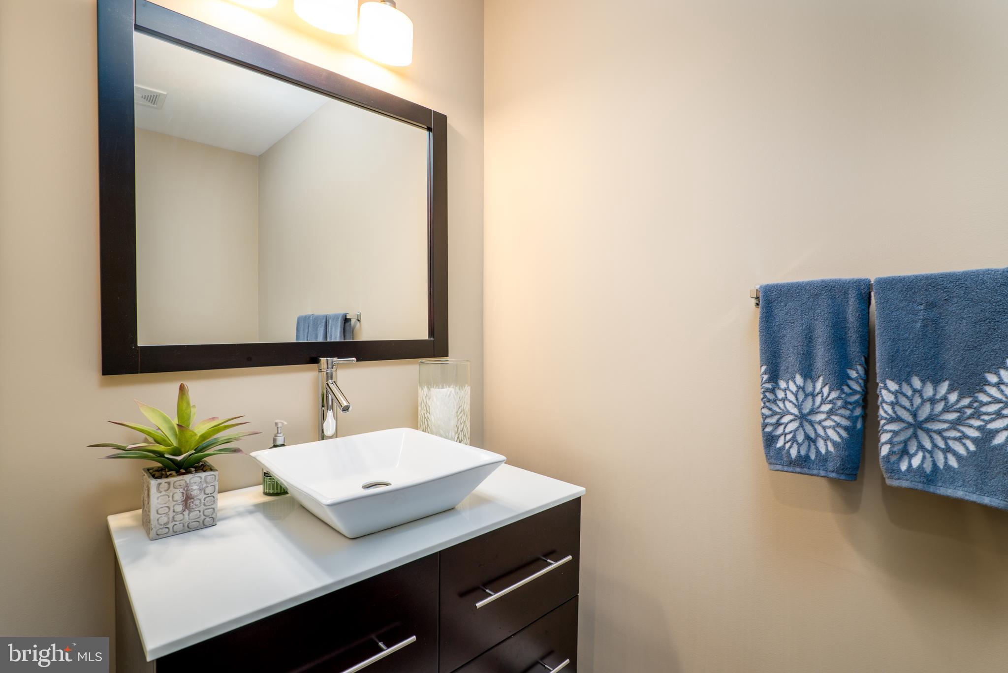 2702 Lighthouse Point East, Unit 637 Baltimore, MD 21224 - Photo 18 of 37 a bathroom with a sink and a mirror