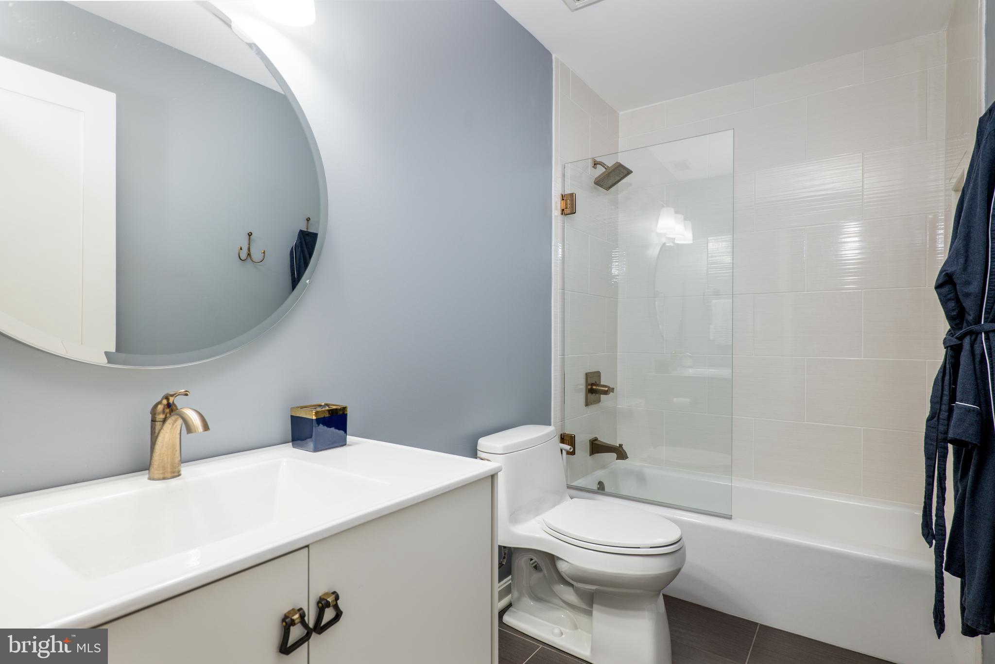 2702 Lighthouse Point East, Unit 637 Baltimore, MD 21224 - Photo 24 of 37 a bathroom with a sink a toilet and shower