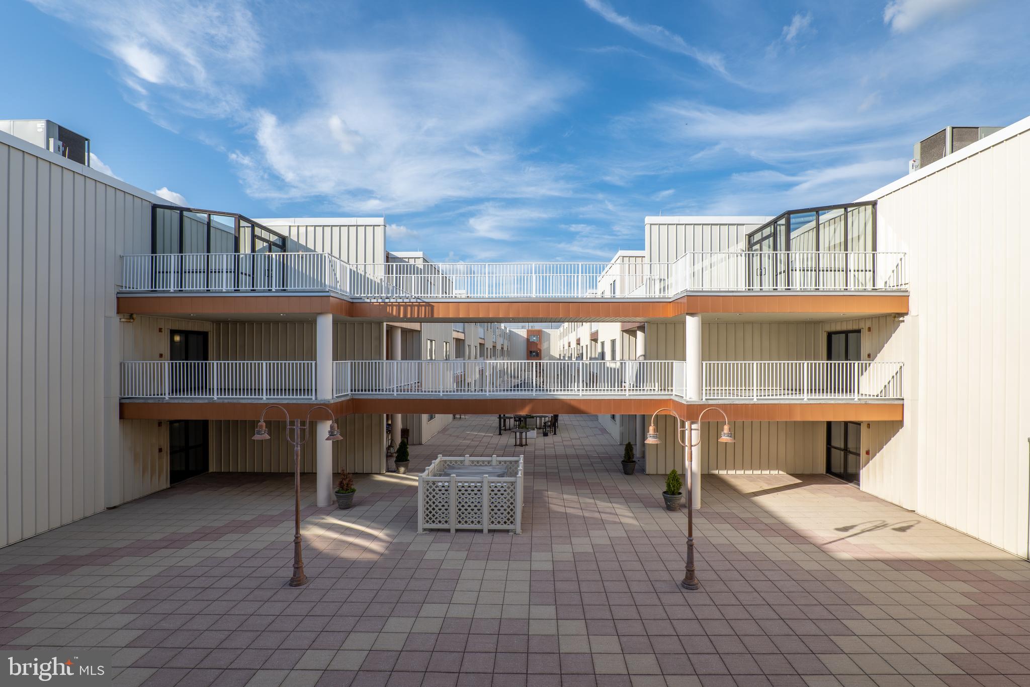 2702 Lighthouse Point East, Unit 637 Baltimore, MD 21224 - Photo 26 of 37 a view of a balcony with chairs