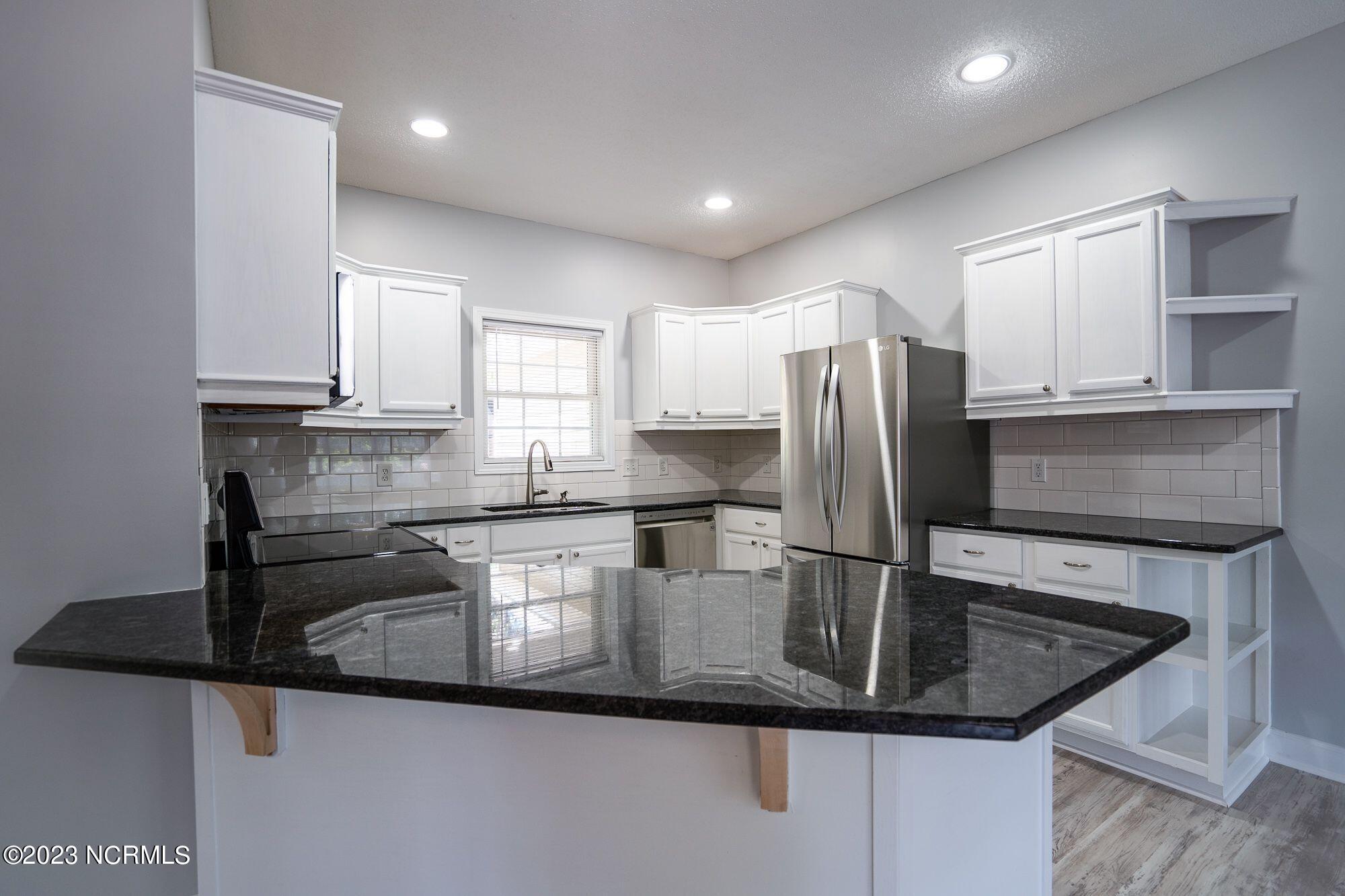10 Red Cedar Lane Pinehurst, NC 28374 - Photo 3 of 27 Peninsula with granite countertops & overhang for seating