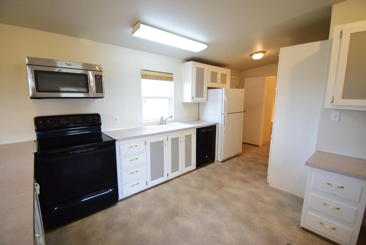 19548 B50 Road Delta, CO 81416 - Photo 9 of 37 a kitchen with a refrigerator stove and sink
