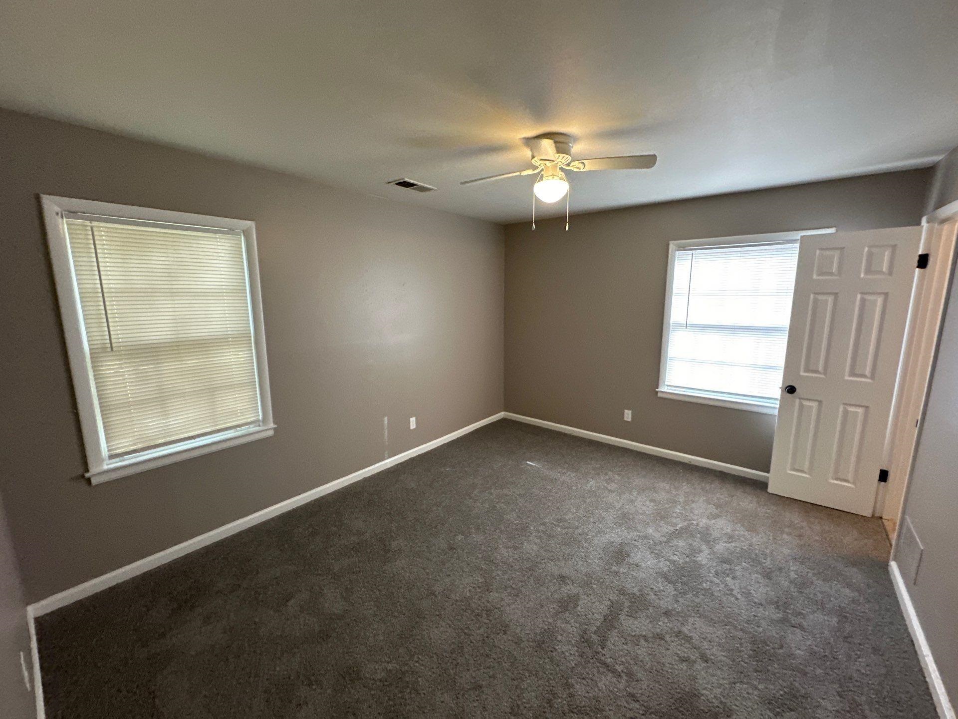 10 West Mitchell Road Memphis, TN 38109 - Photo 4 of 11 an empty room with windows and fan