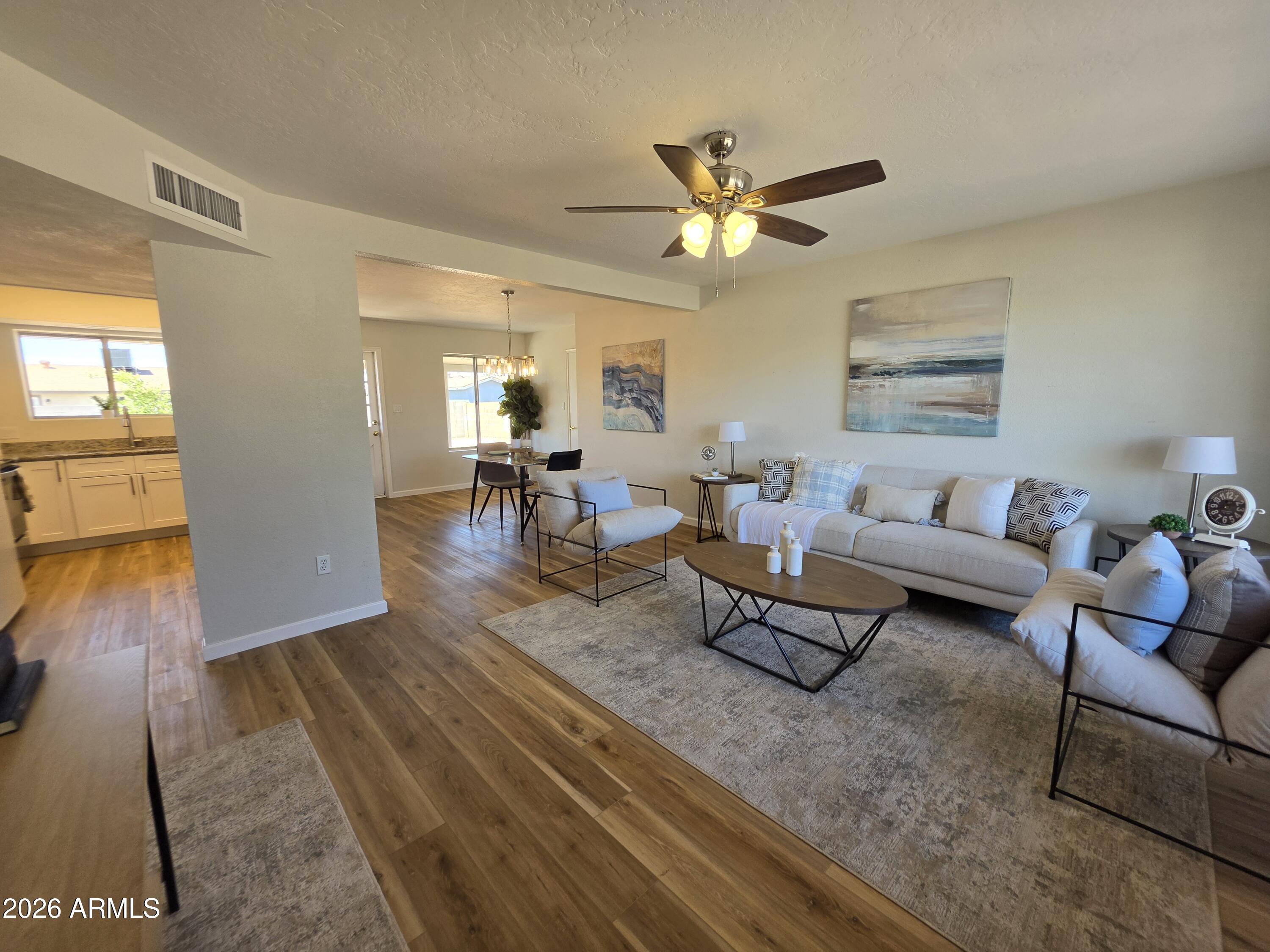 46 East McLellan Road Mesa, AZ 85201 - Photo 2 of 18 a living room with furniture and wooden floor