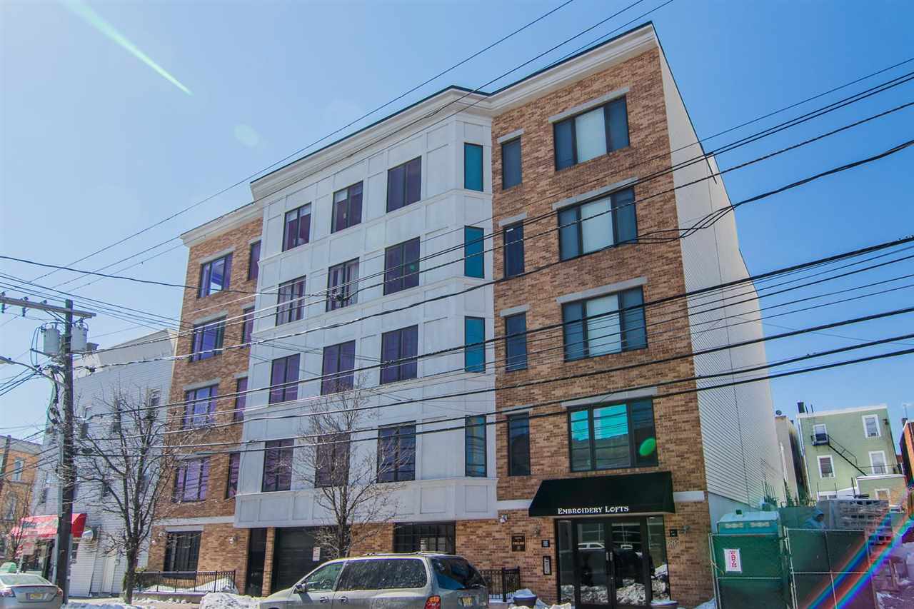 a front view of a building with lot of cars