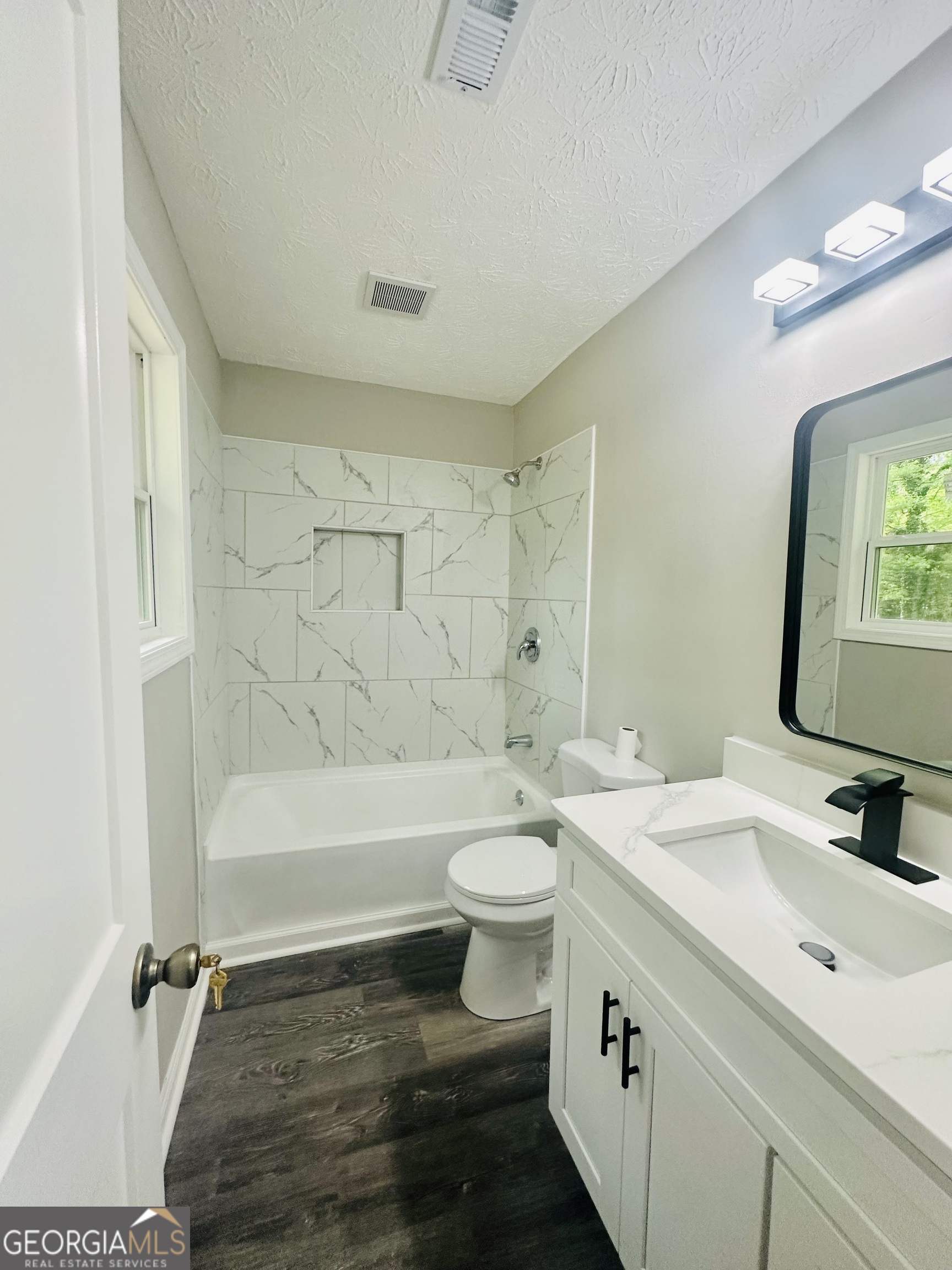 70 Darwin Drive Jonesboro, GA 30238 - Photo 13 of 19 a bathroom with a double vanity sink toilet mirror and bathtub