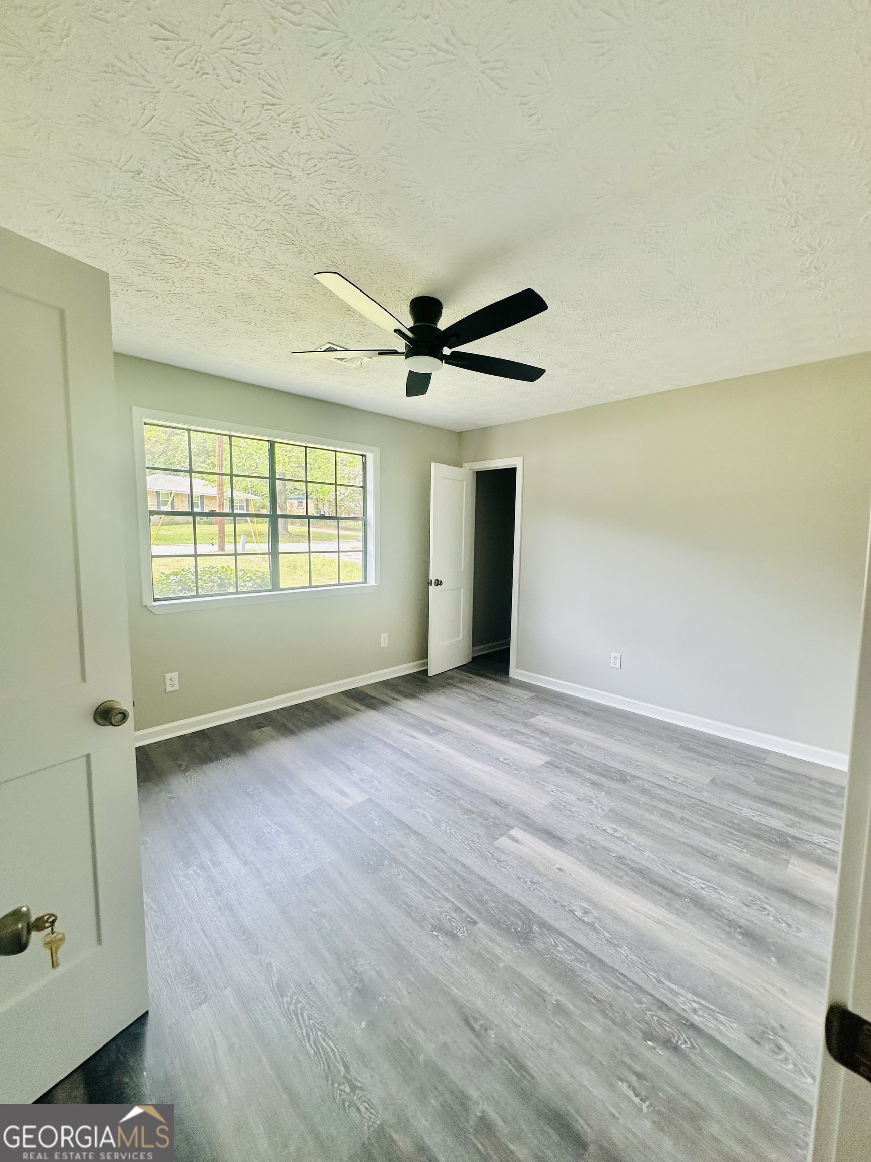 70 Darwin Drive Jonesboro, GA 30238 - Photo 14 of 19 wooden floor in an empty room with a window