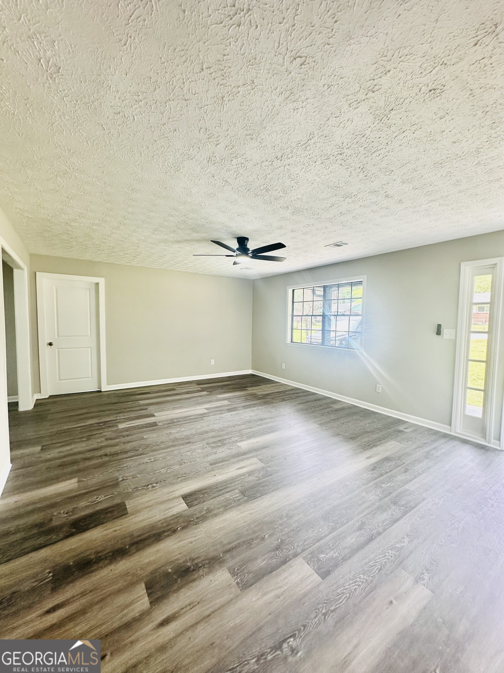 70 Darwin Drive Jonesboro, GA 30238 - Photo 8 of 19 a view of empty room with wooden floor and fan