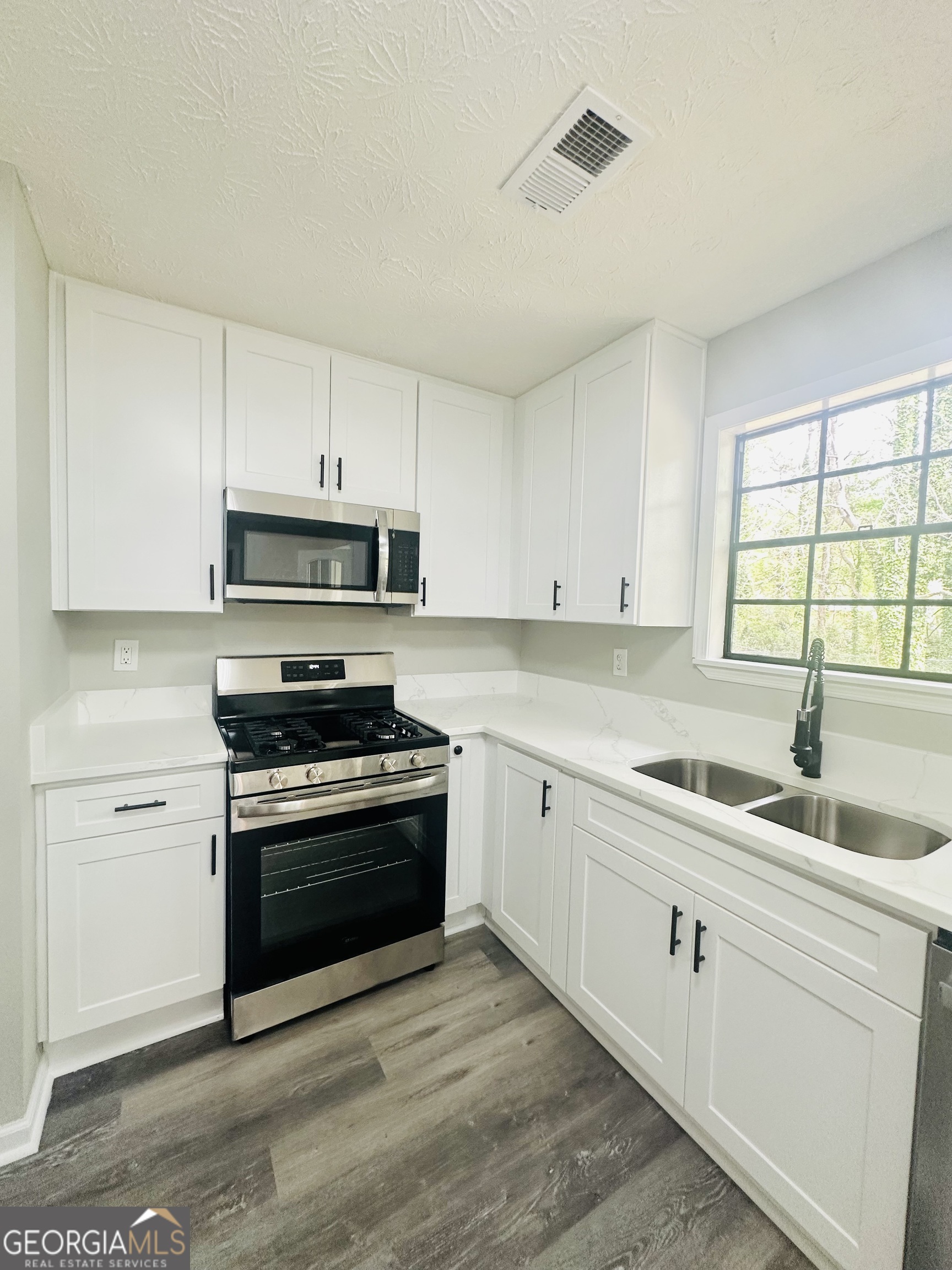 70 Darwin Drive Jonesboro, GA 30238 - Photo 10 of 19 a kitchen with stainless steel appliances granite countertop a sink and a stove