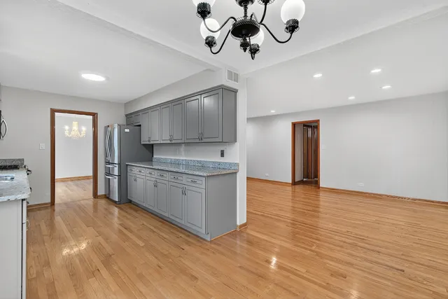 a kitchen with stainless steel appliances granite countertop a sink and a stove top oven