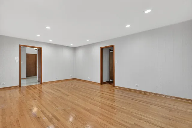 a view of an empty room with wooden floor