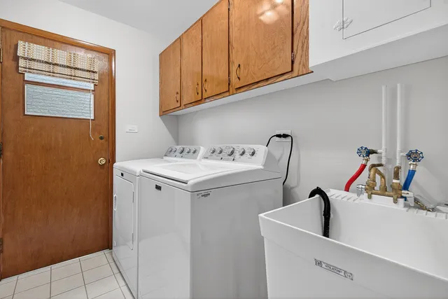 a utility room with a sink dryer and washer
