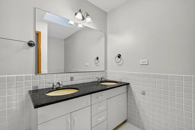 a sink with a mirror and vanity