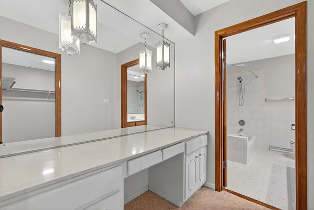 a bathroom with a shower sink and mirror