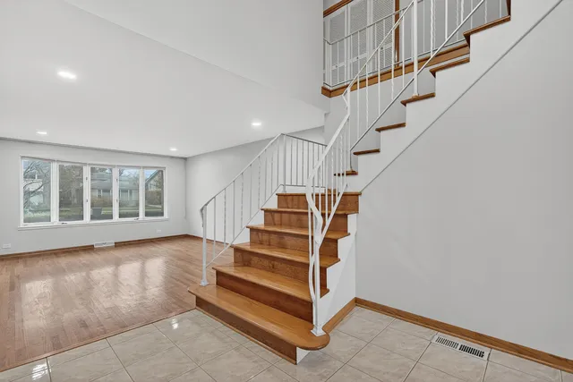 a view of entryway with stairs and wooden floor