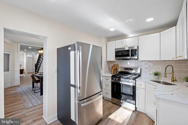 a kitchen with a refrigerator stove and sink