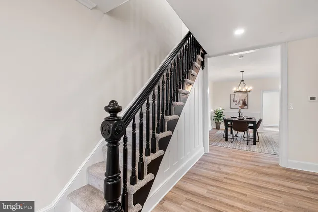 a view of a hallway with wooden floor and staircase