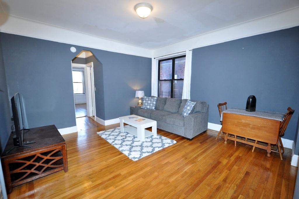 Spacious Living Room with a walk-in closet and hardwood floors.