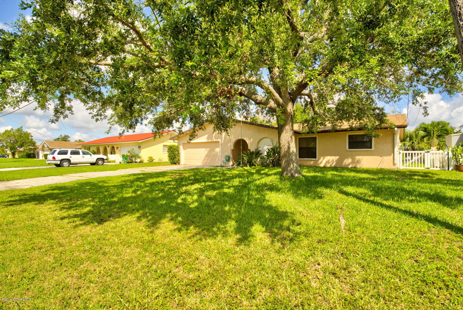 1005 Audubon Road Merritt Island, FL 32953 - Photo 2 of 39 a view of house with garden space and trees
