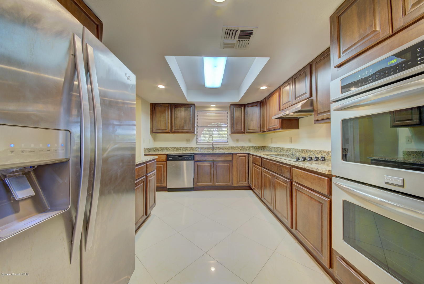 1005 Audubon Road Merritt Island, FL 32953 - Photo 11 of 39 a large kitchen with stainless steel appliances kitchen island granite countertop a stove a sink dishwasher and a refrigerator