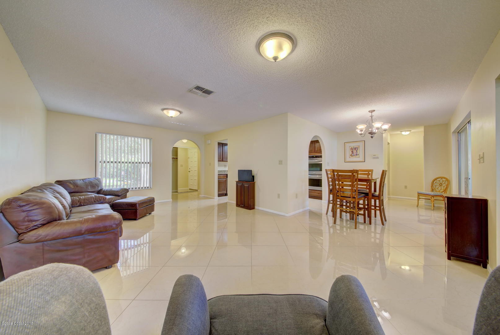 1005 Audubon Road Merritt Island, FL 32953 - Photo 13 of 39 a living room with furniture and wooden floor