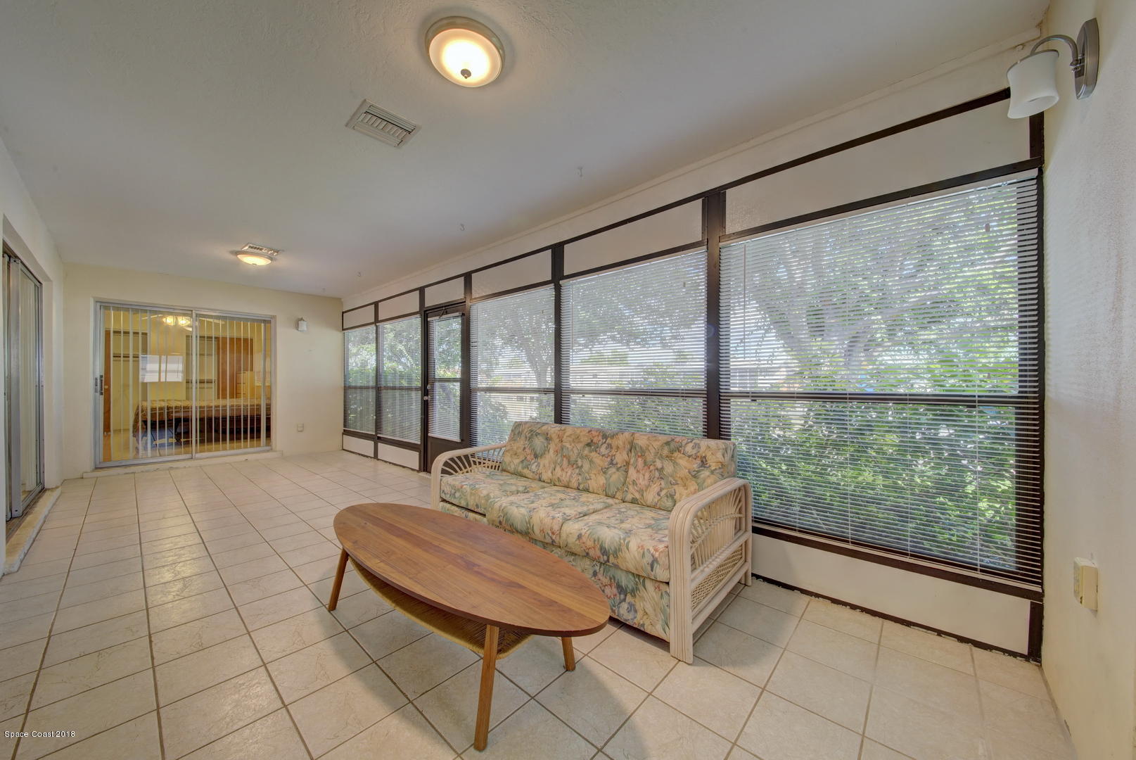 1005 Audubon Road Merritt Island, FL 32953 - Photo 19 of 39 a spacious bedroom with a large bed and a large window