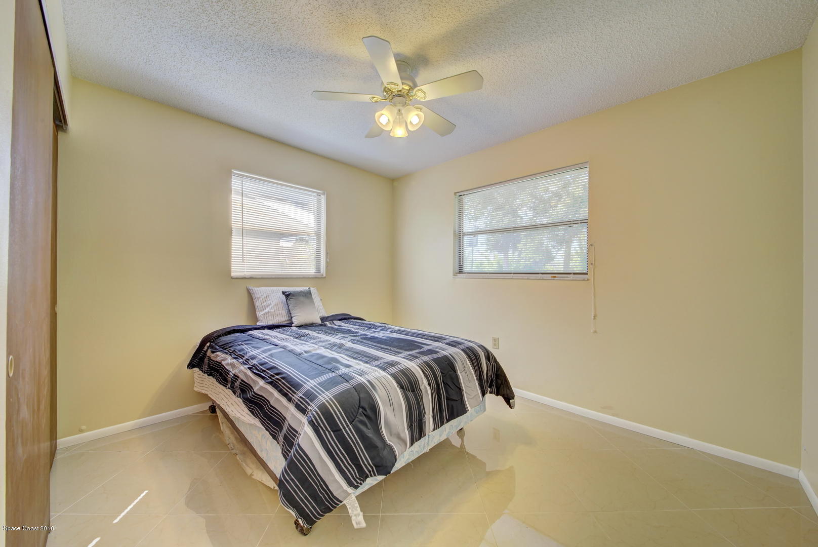 1005 Audubon Road Merritt Island, FL 32953 - Photo 23 of 39 a bedroom with a bed and a painting on the wall