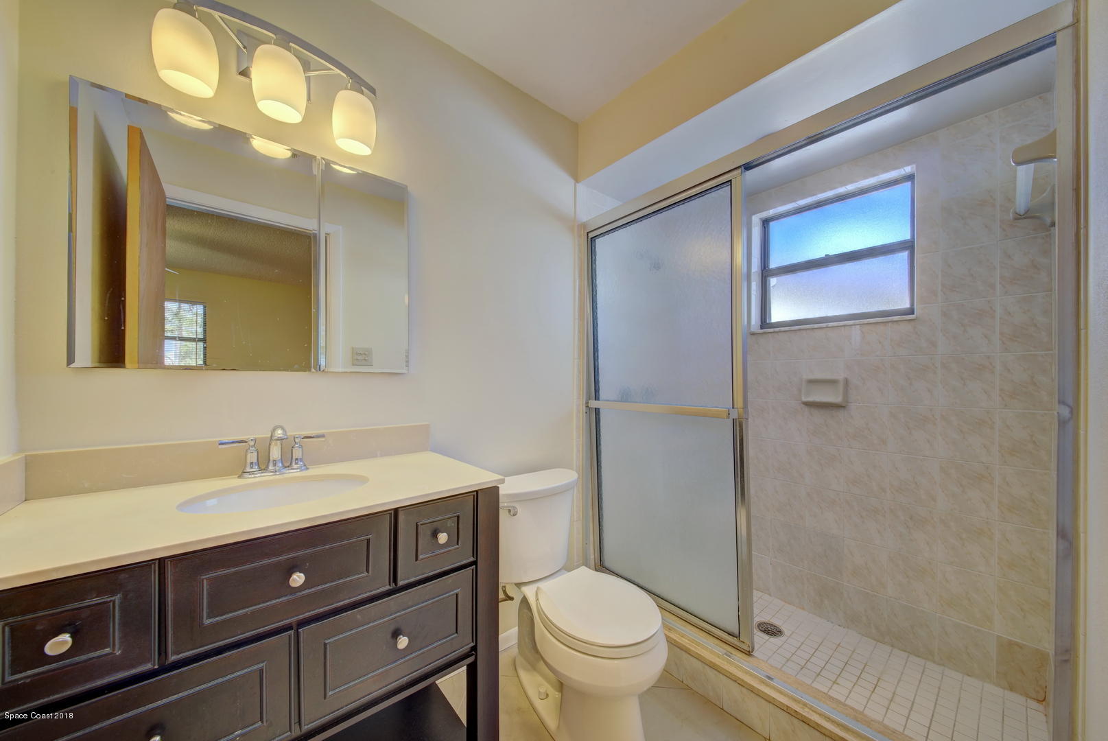 1005 Audubon Road Merritt Island, FL 32953 - Photo 26 of 39 a bathroom with a sink a toilet and shower