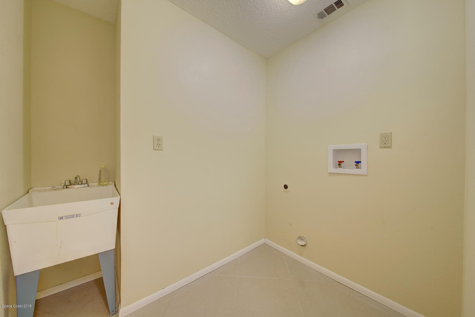 1005 Audubon Road Merritt Island, FL 32953 - Photo 31 of 39 a bathroom with a sink and a mirror