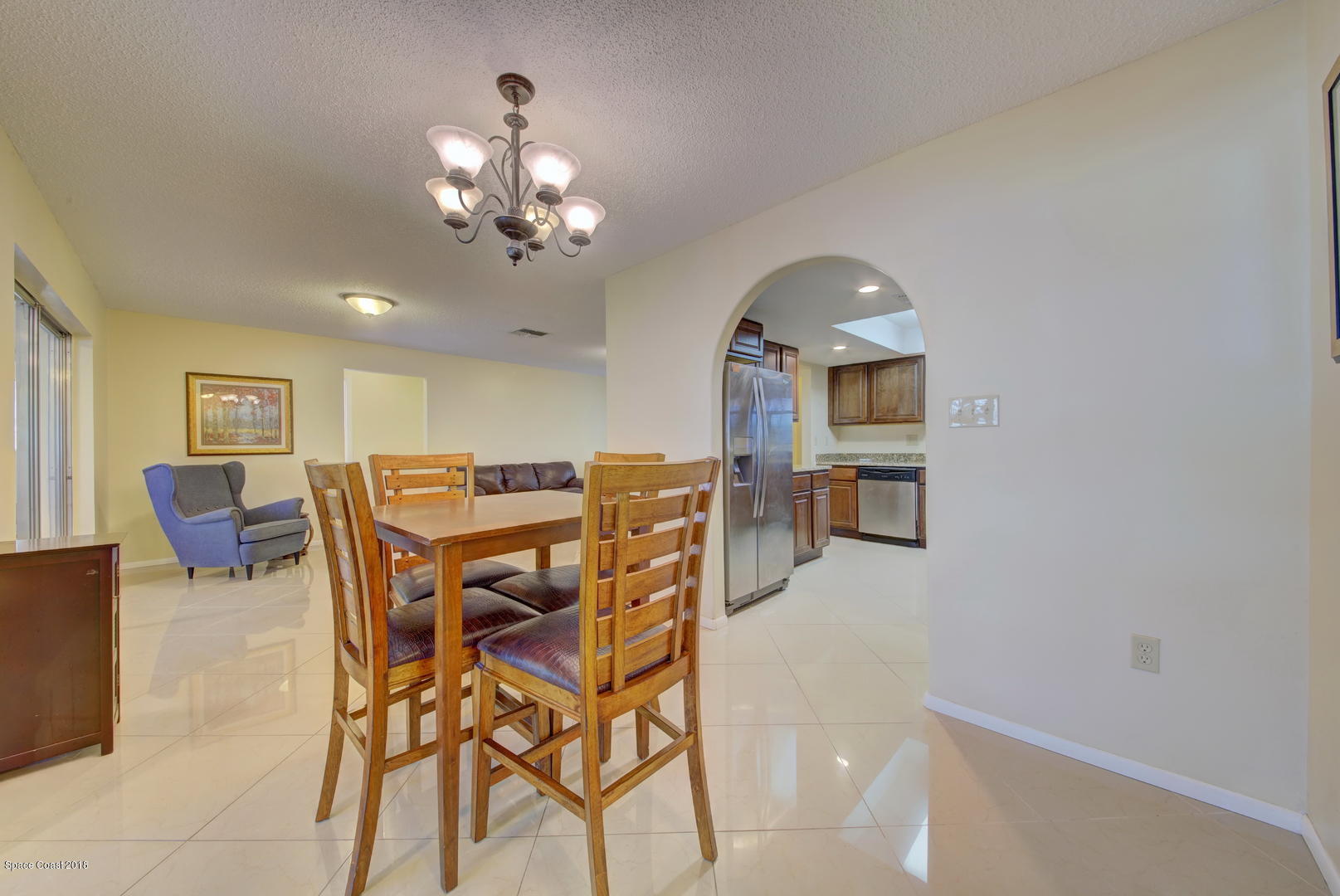 1005 Audubon Road Merritt Island, FL 32953 - Photo 6 of 39 a view of a dining room with furniture and a chandelier