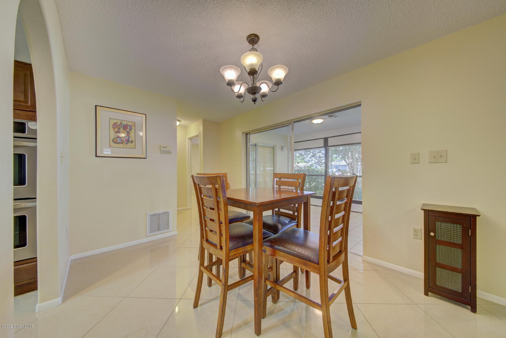 1005 Audubon Road Merritt Island, FL 32953 - Photo 7 of 39 a dining room with furniture and chandelier fan