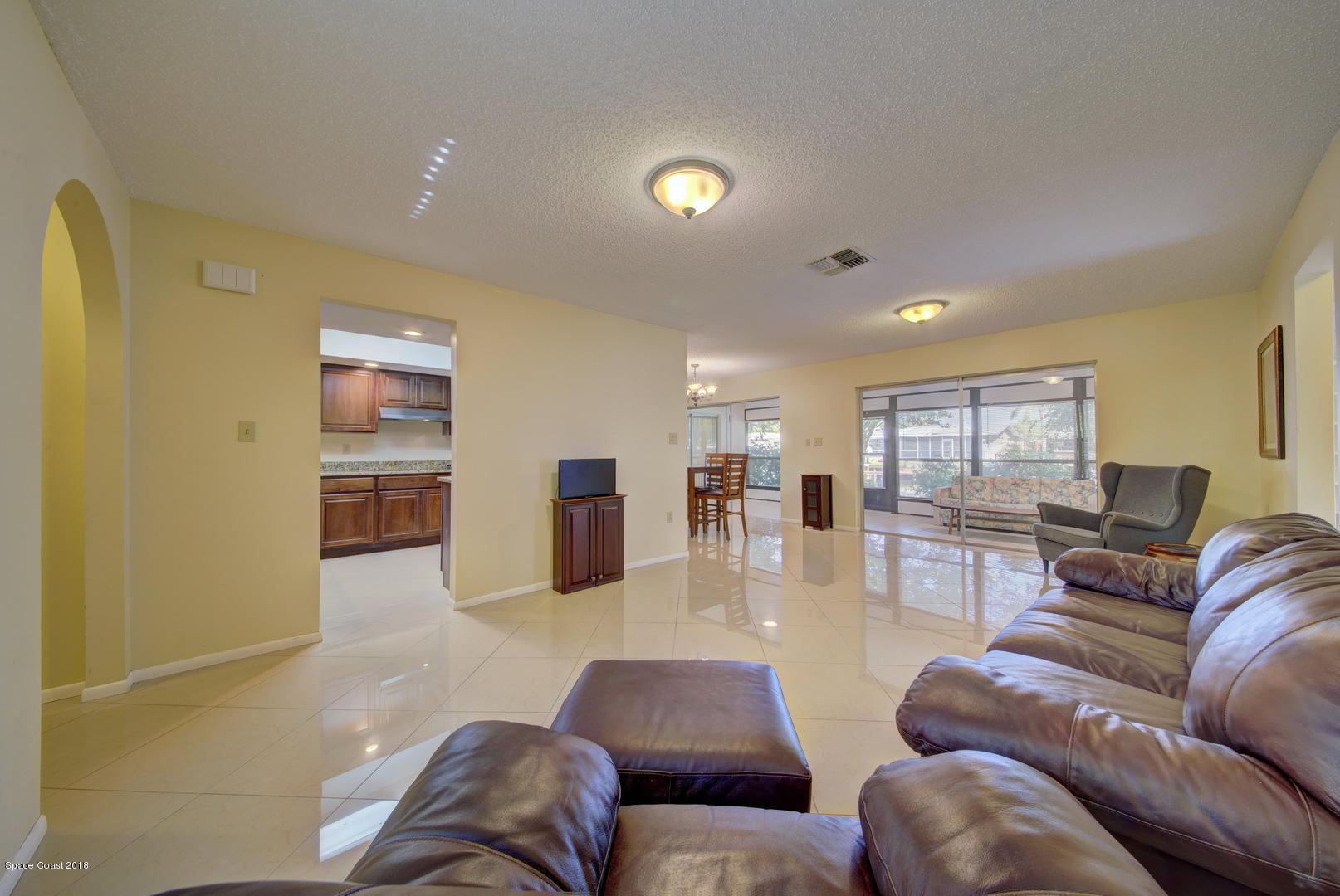 1005 Audubon Road Merritt Island, FL 32953 - Photo 8 of 39 a living room with furniture and kitchen view