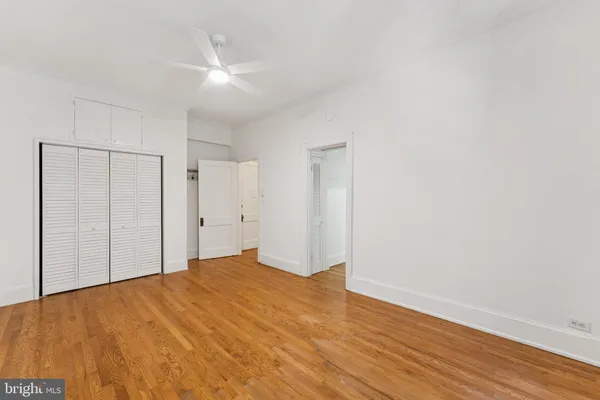 a view of empty room with wooden floor