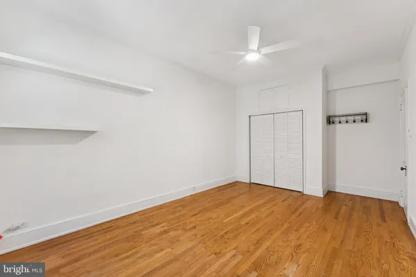 a view of walk in closet with empty racks